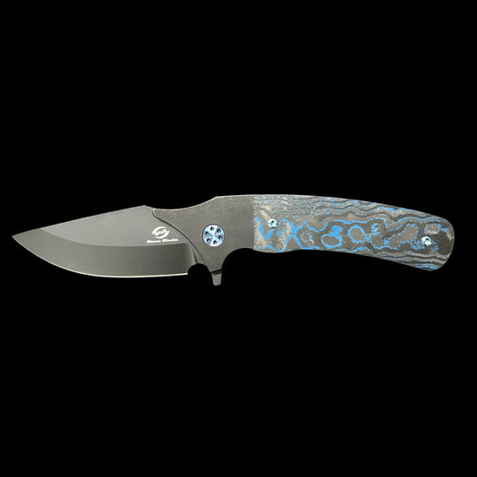 BEANS BLADES Javelin M390 Black PVD Drop Point, Titanium Black PVD handles with Electric Blue Camo Carbon.